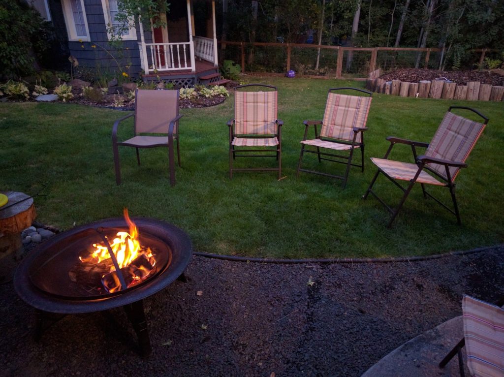 Installing a fire pit in backyard to enliven the place and covering the lawn tool